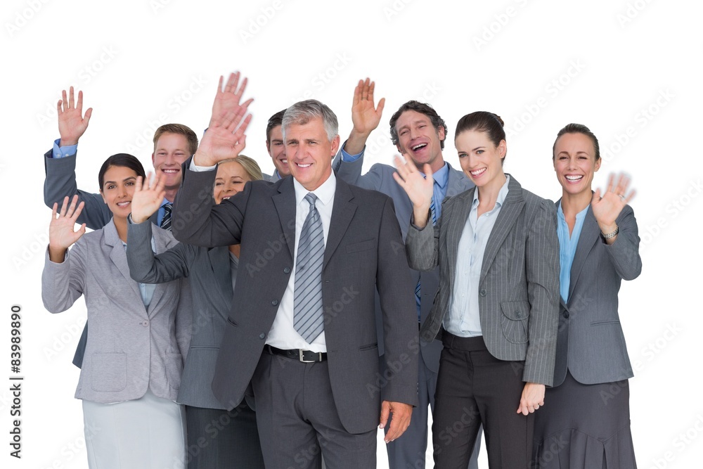 Smiling business team waving at camera Smiling business team waving at camera