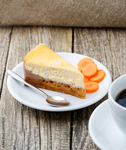 Sweet slice of carrot cake with coffee cup.