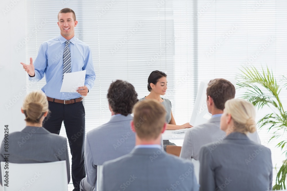 Smiling businessman talking during conference Smiling businessman talking during conference