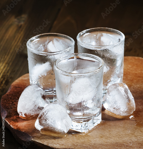 Сold fresh water with ice in a heart shape in the misted glasse