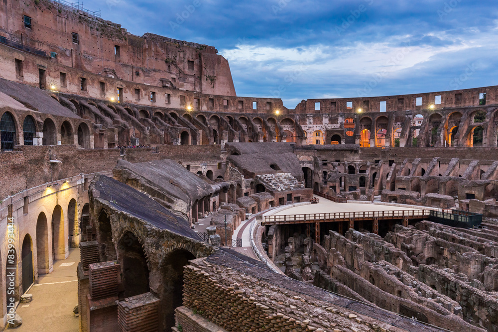 Internal view of the Coliseum at dusk in Rome, Italy. 