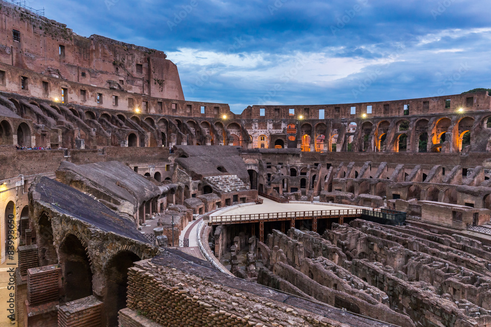 Internal view of the Coliseum at night in Rome, Italy