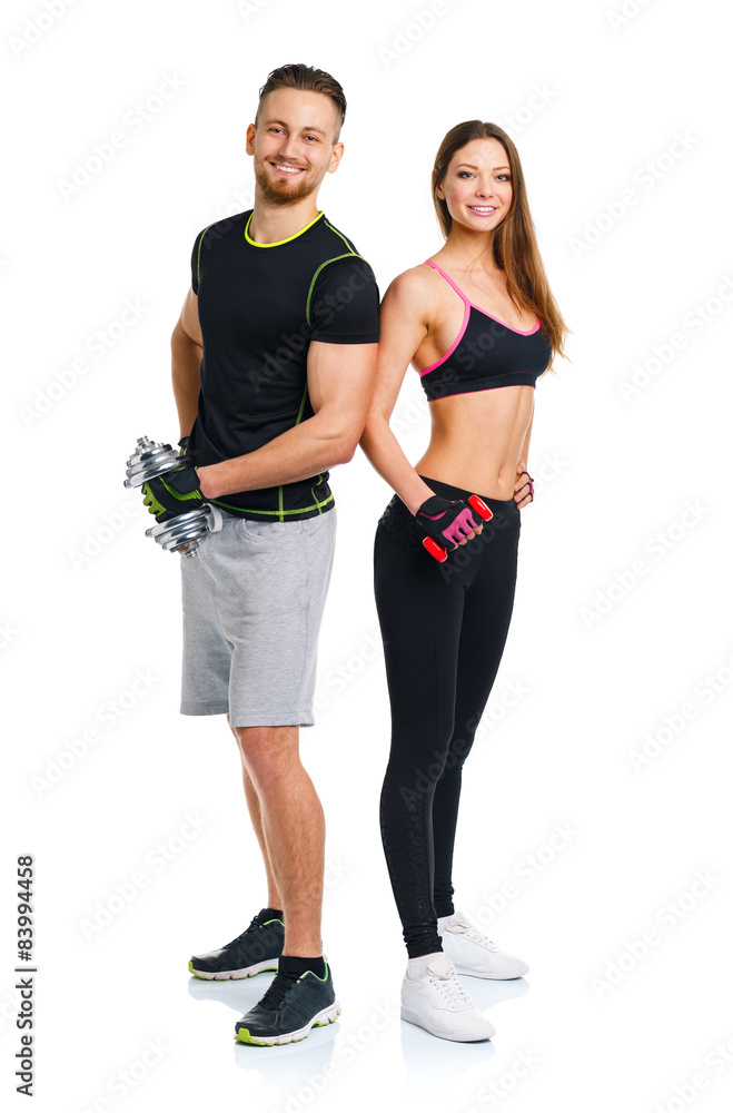 Sport couple - man and woman with dumbbells on the white Sport couple - man and woman with dumbbells on the white