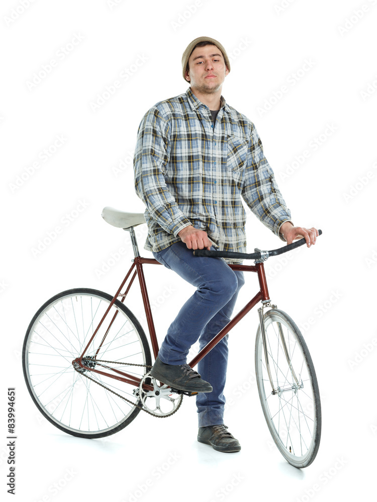 Young man doing tricks on fixed gear bicycle on a white Young man doing tricks on fixed gear bicycle on a white
