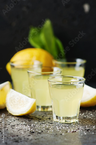 Italian traditional liqueur limoncello with lemon