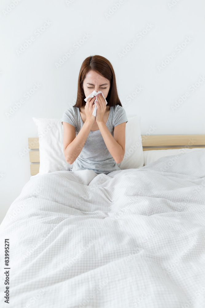 Woman feeling unwell and runny nose at bedroom Woman feeling unwell and runny nose at bedroom