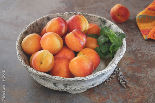 Beautiful ripe apricots in a ceramic bowl, close up
