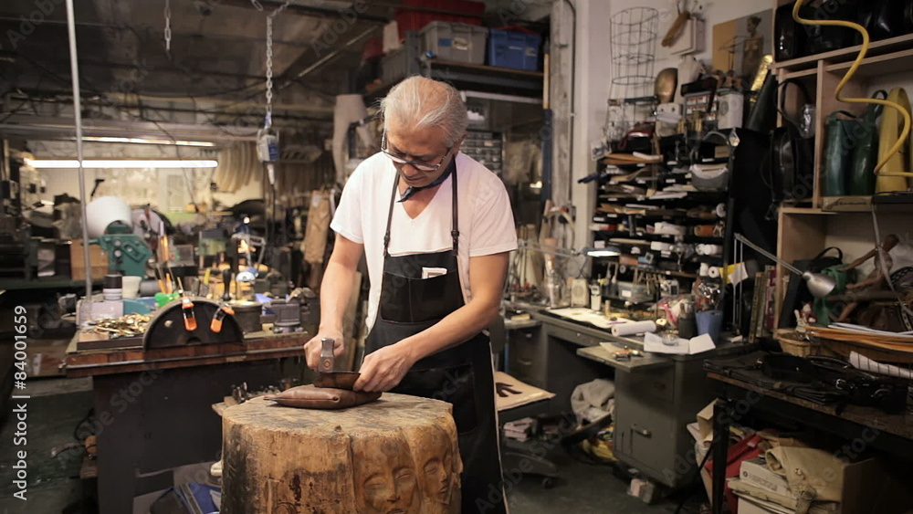 An older gentleman smiles for the camera while in his workshop An older gentleman smiles for the camera while in his workshop