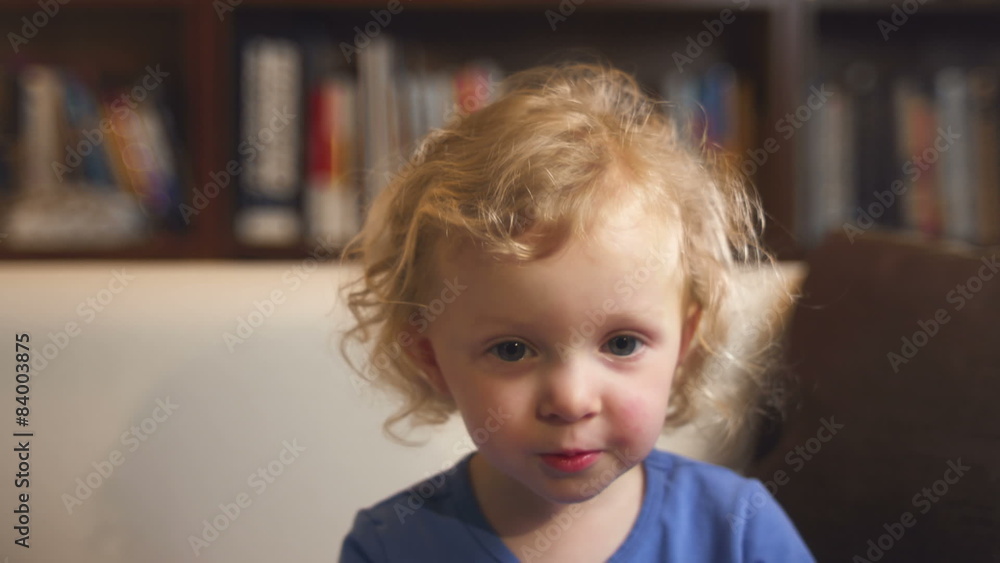 An adorable little girl sits in front of the camera and video chats. Close up. An adorable little girl sits in front of the camera and video chats. Close up.