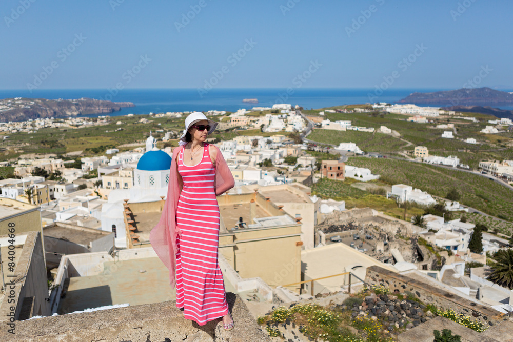 Obraz premium Woman in a long dress,Santorini, Greece.