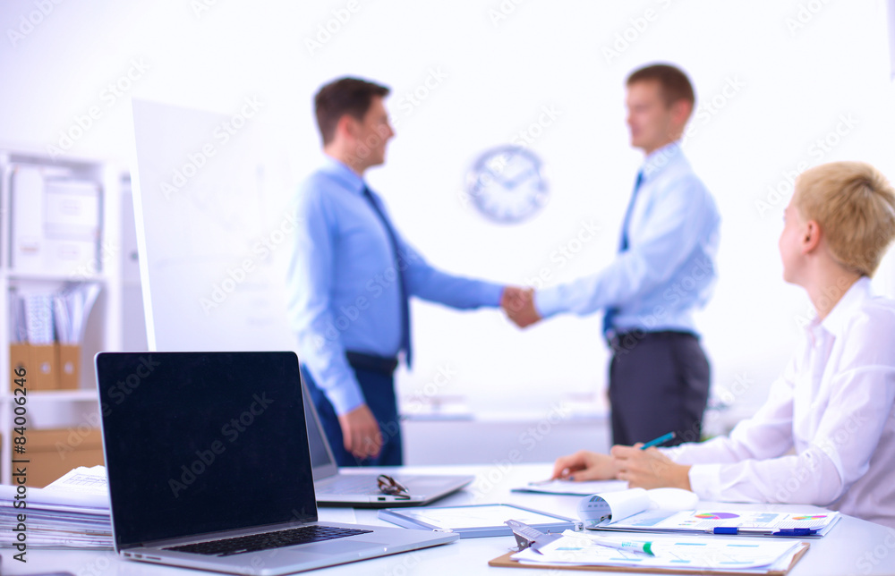Business people shaking hands, finishing up a meeting Business people shaking hands, finishing up a meeting