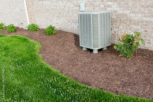 Air conditioner condenser heat pump unit standing outdoors