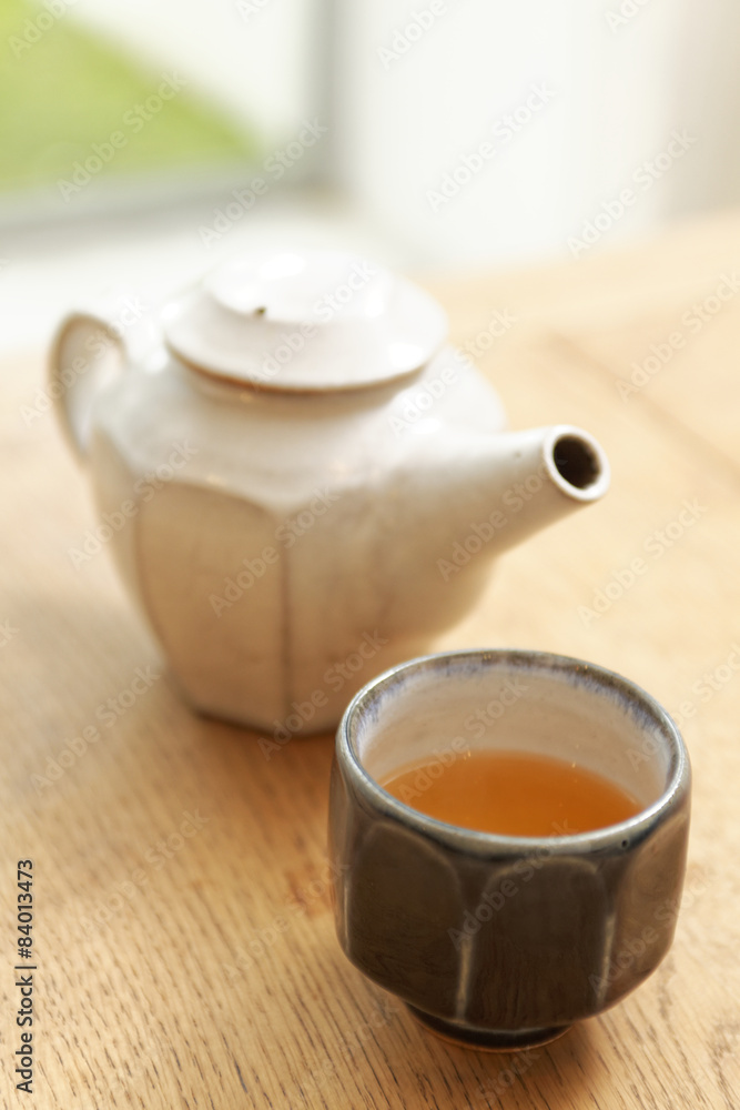 kettle and tea cup on table kettle and tea cup on table