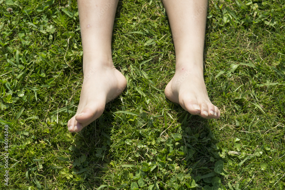 Feet of boy lying down on the grass Feet of boy lying down on the grass