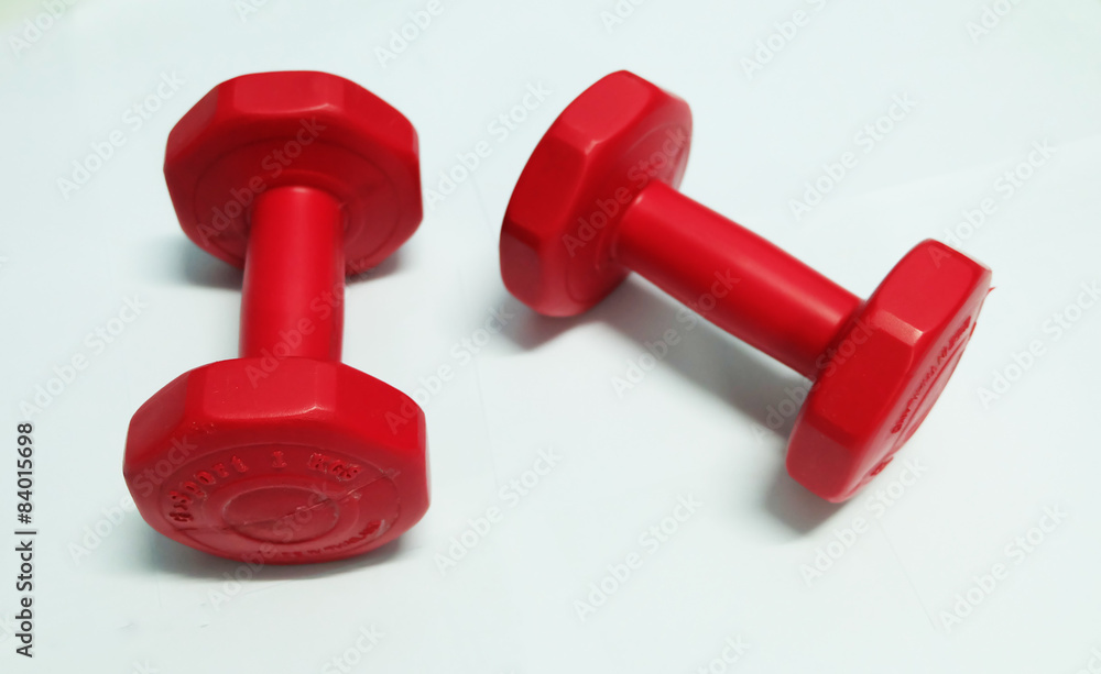 Red dumbbells weight on White. Red dumbbells weight on White.
