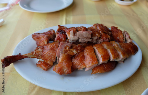 Roasted duck leg  sliced portions on plate, Chinese cuisine