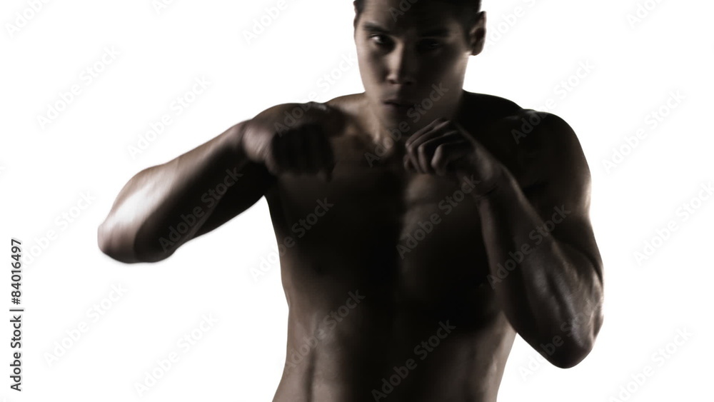 Close up of an ethnic athlete shadow boxing into the camera on a white background Close up of an ethnic athlete shadow boxing into the camera on a white background