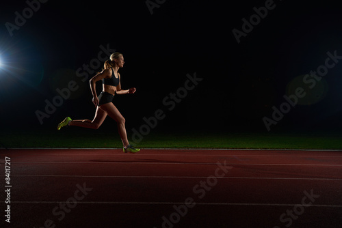 Athletic woman running on track