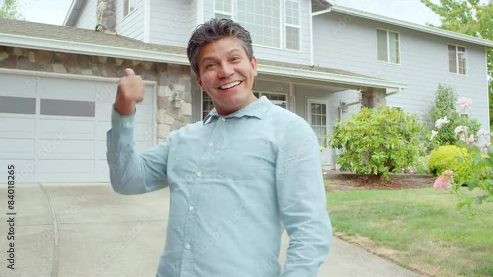 An excited man stands in front of his house and then invites us in as he walks up his driveway to go inside An excited man stands in front of his house and then invites us in as he walks up his driveway to go inside