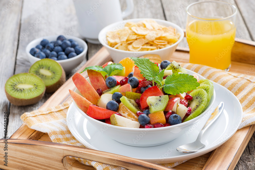 breakfast with fruit salad, cornflakes and orange juice breakfast with fruit salad, cornflakes and orange juice