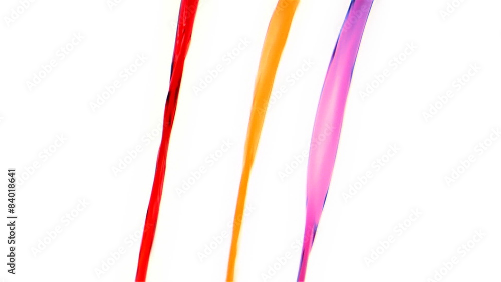 Three streams of colorful liquids being poured Three streams of colorful liquids being poured