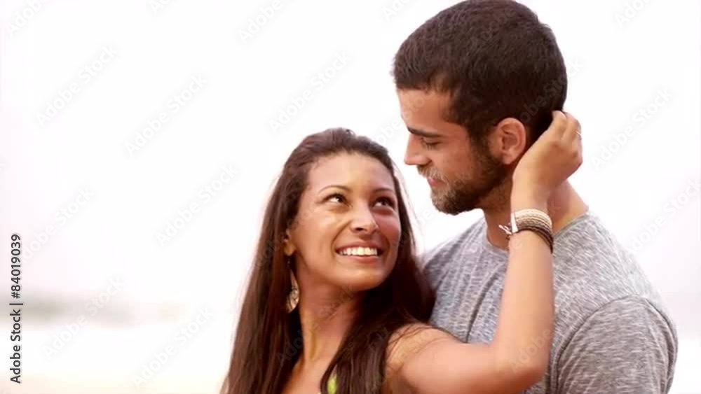 Brazilian couple smiles on a beach in Brazil Brazilian couple smiles on a beach in Brazil