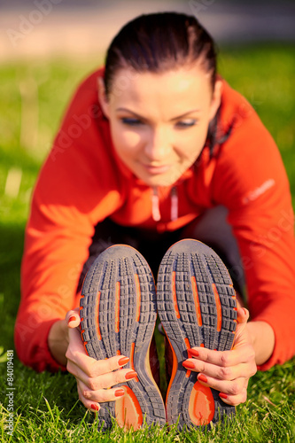 Stretching athlete warming up for a workout outdoors. healthy 