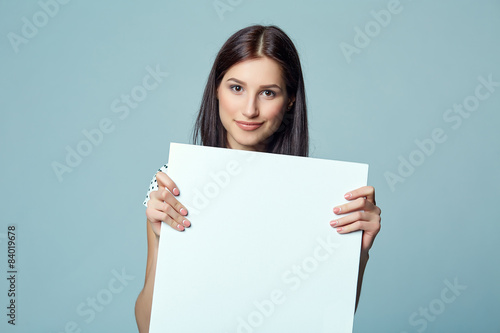 Lady beautiful woman standing behind, holding white blank 