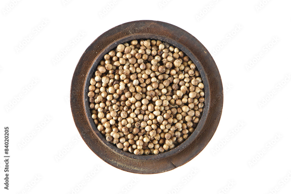 Coriander dried  in wood bowl on isolated white., Top view