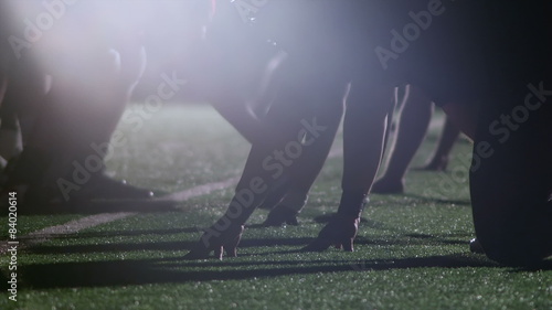 Close up view of football player's hands on the ground ready to snap the ball
 photo