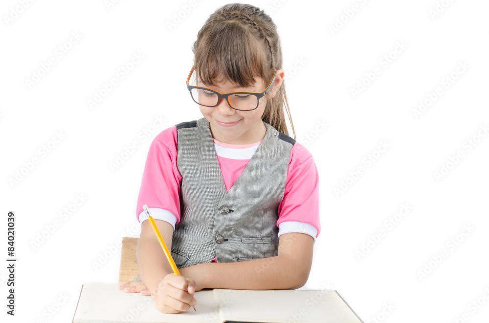 Little girl writhing with notebook and penceil on white backgrou Little girl writhing with notebook and penceil on white backgrou