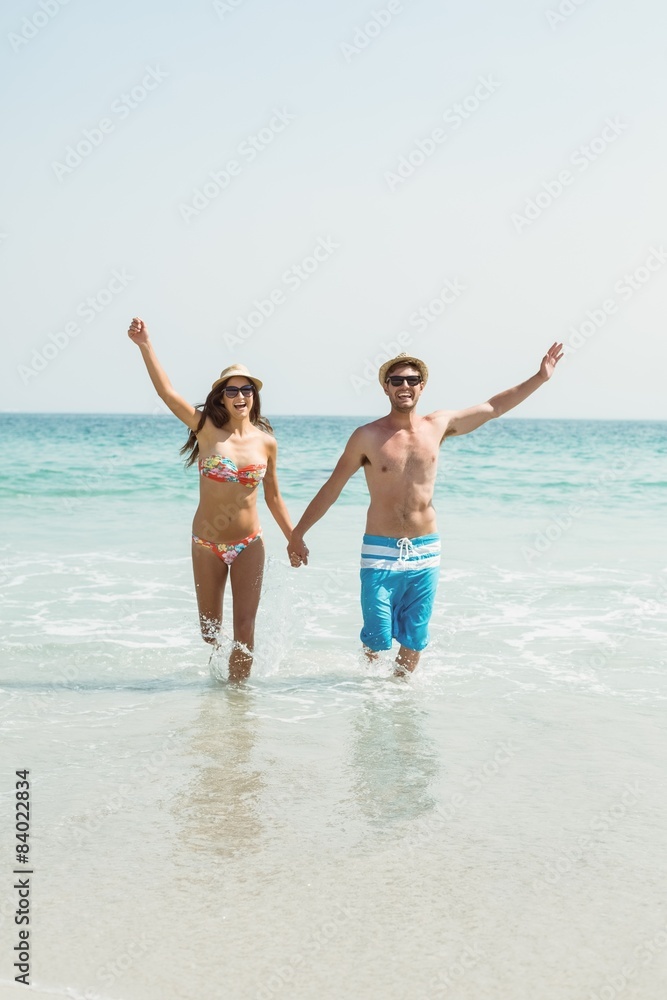 happy couple running on the sea 