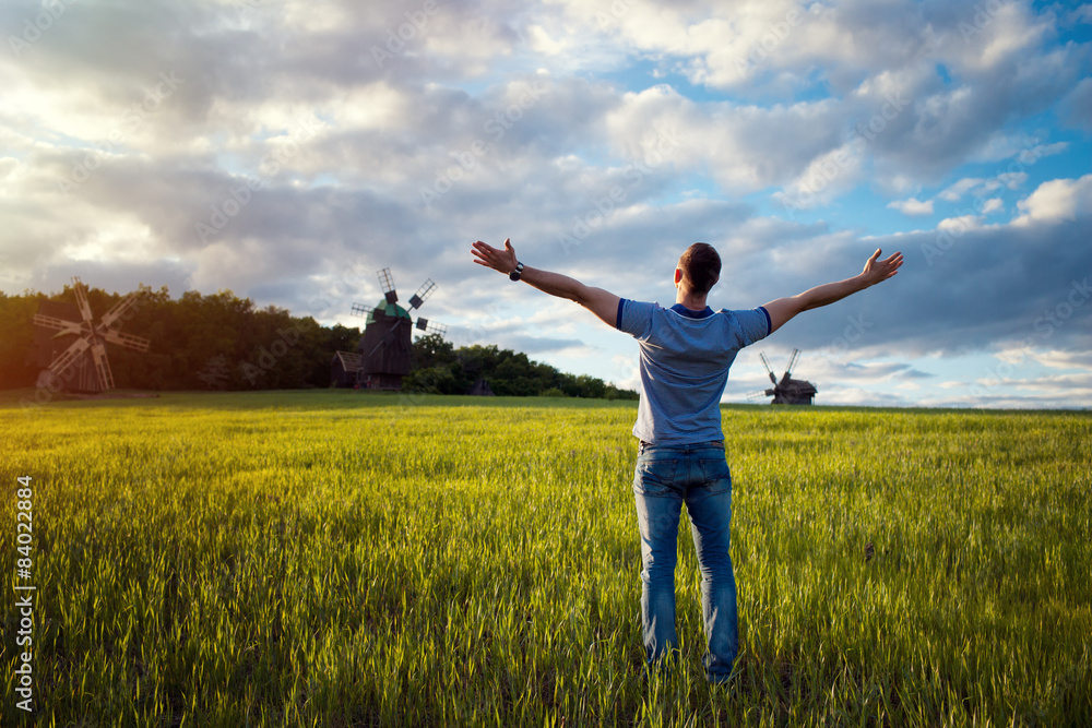 Man on nature background with arms outstretched. Free man Man on nature background with arms outstretched. Free man