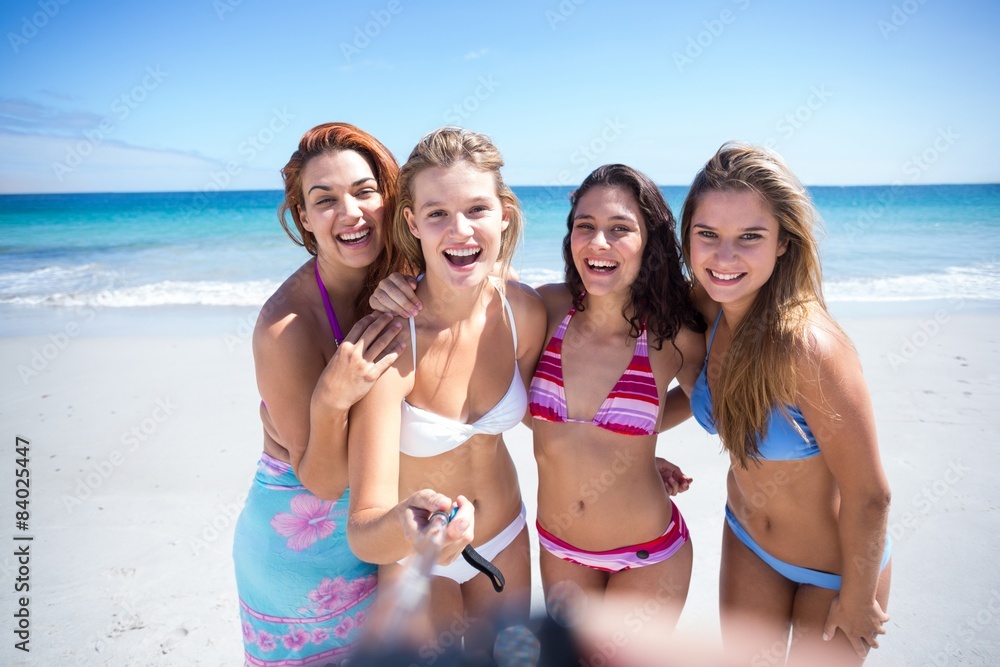 Happy friends doing pictures with selfie stick