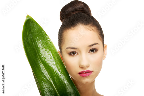 Beautiful woman with green leaf.