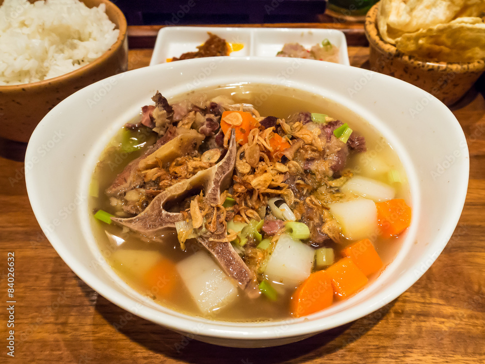 Sop buntuk (oxtail soup) served with rice and crackers Sop buntuk (oxtail soup) served with rice and crackers