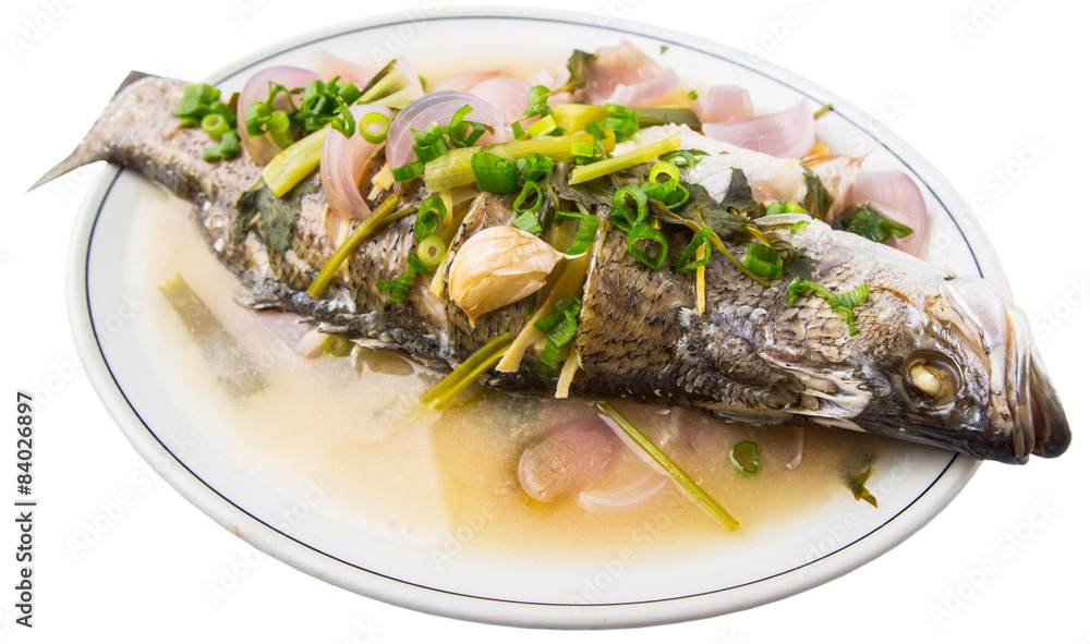 Malaysian dish of sweet and sour steamed Asian bass fish Malaysian dish of sweet and sour steamed Asian bass fish