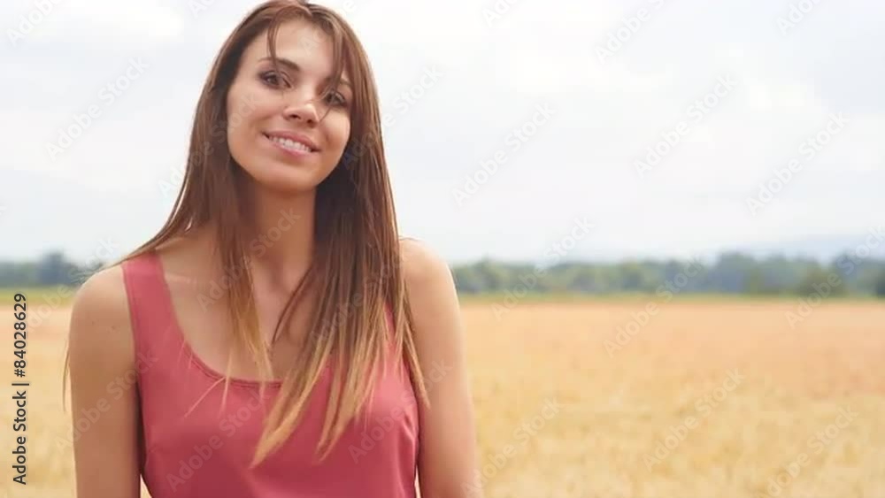 Beautiful Brunette Smiles in a Wheat Field Beautiful Brunette Smiles in a Wheat Field