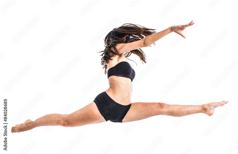 Young ballet dancer jumping over white background