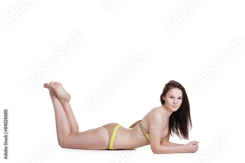 Portrait of a beautiful brunette girl wearing  yellow bikini