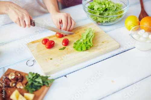Cutting tomatoes and lettuce