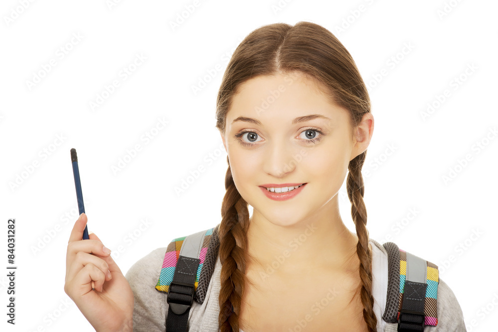 Obraz premium Thoughtful teenage girl with a pen.