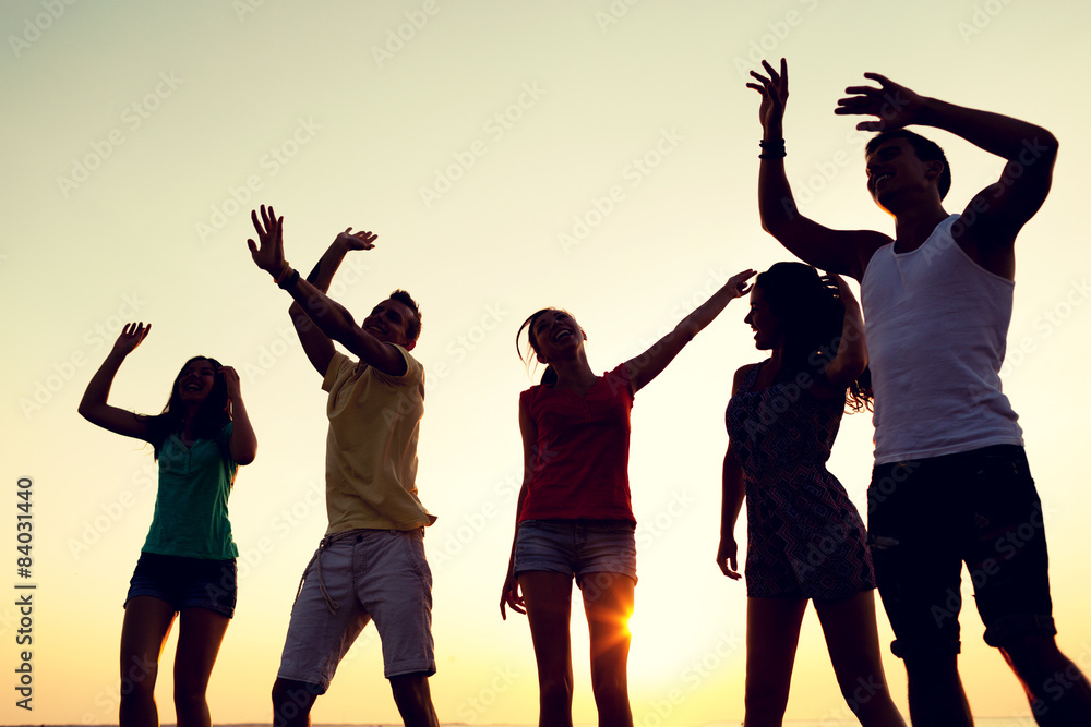Fototapeta premium smiling friends dancing on summer beach