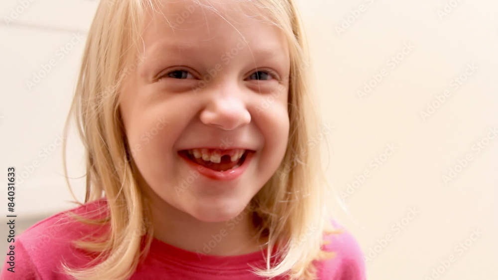 Cute little girl shows off her tooth to the camera Cute little girl shows off her tooth to the camera