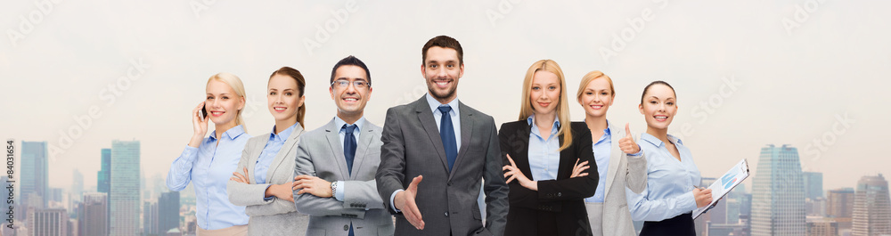 group of smiling businessmen making handshake group of smiling businessmen making handshake