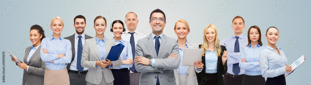 group of happy businesspeople over blue background group of happy businesspeople over blue background