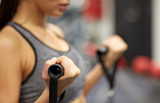 close up of woman exercising on gym machine