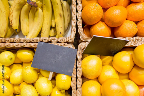 fruits in baskets with nameplates at food market