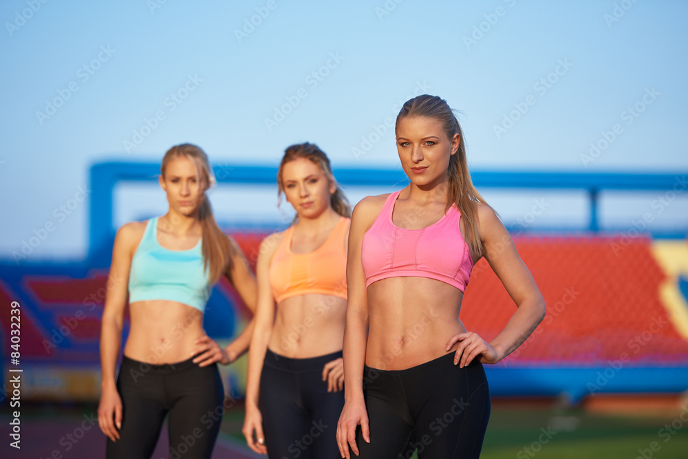 athlete woman group running on athletics race track athlete woman group running on athletics race track