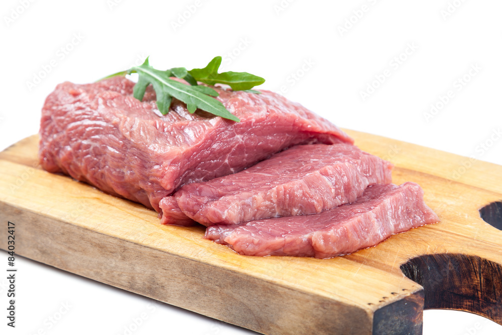 Meat on a cutting board on white background. Meat on a cutting board on white background.